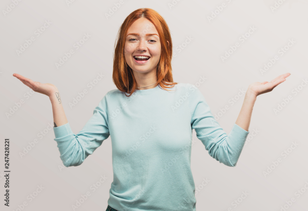 portrait of a pretty redhead girl doubting between two things portrait of a pretty redhead girl doubting between two things