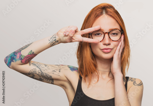 portrait of a pretty redhead girl doing cool gesure
