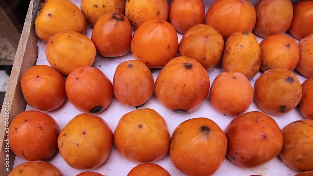 Fresh ripe persimmons in the supermarket Fresh ripe persimmons in the supermarket