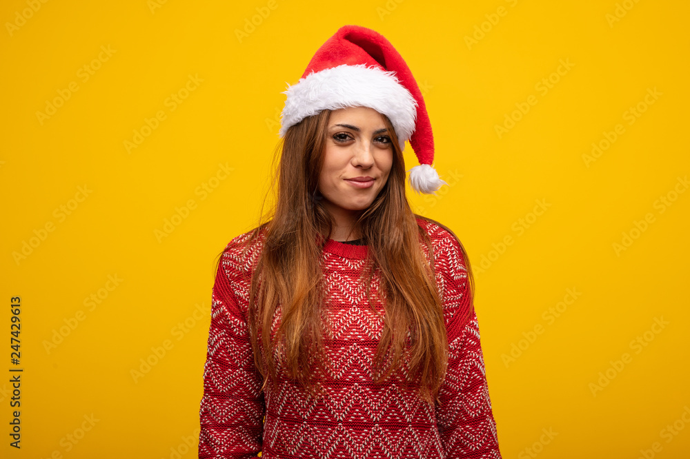 Young woman wearing santa hat thinking about an idea Young woman wearing santa hat thinking about an idea