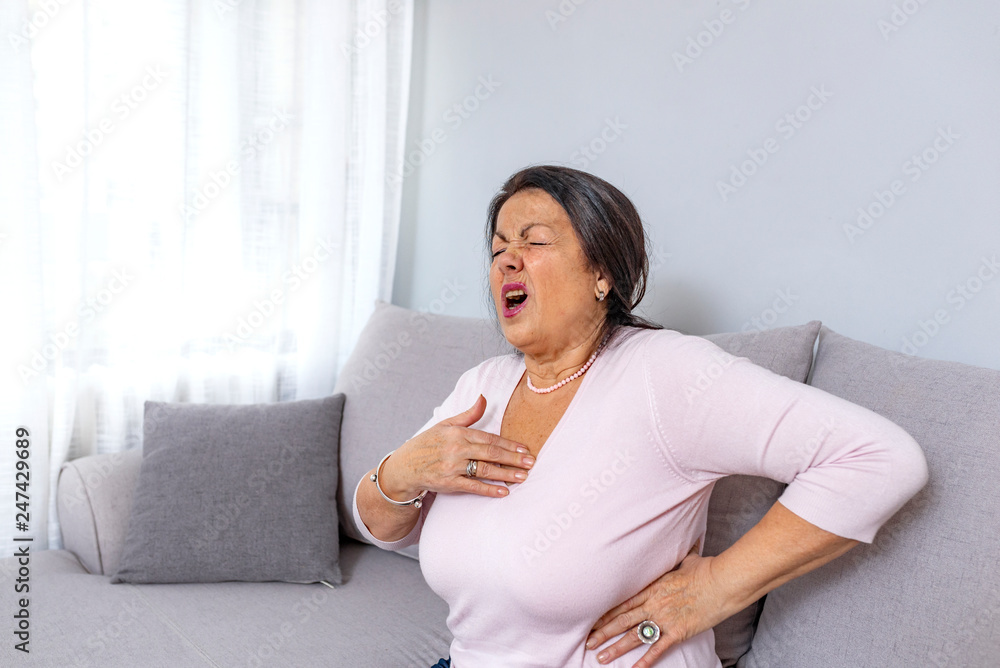 Heart attack concept. Woman suffering from chest pain, Health care. Severe heartache, Having heart attack or Painful cramps, Pressing on chest with painful expression. Heart attack concept. Woman suffering from chest pain, Health care. Severe heartache, Having heart attack or Painful cramps, Pressing on chest with painful expression.