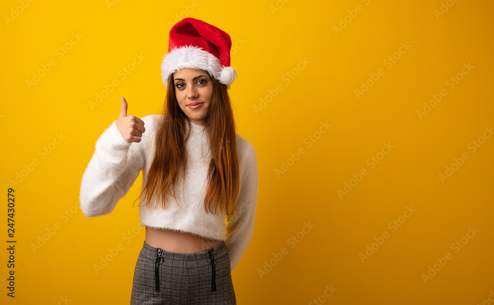 Young pretty woman holding gift smiling and raising thumb up Young pretty woman holding gift smiling and raising thumb up