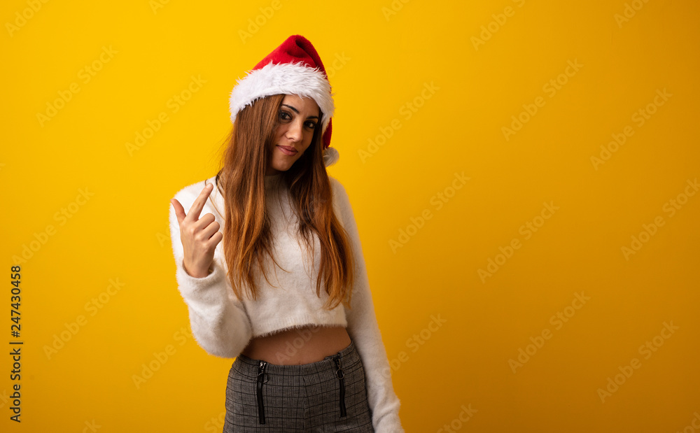 Young pretty woman holding gift inviting to come Young pretty woman holding gift inviting to come