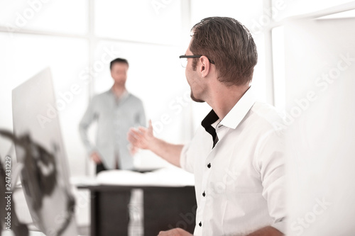 businessman talking with a colleague in the workplace