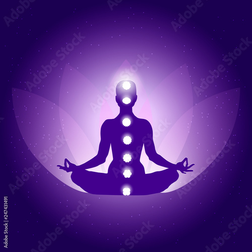 Silhouette of Person in yoga lotus asana on dark blue purple background with lotus flower and light