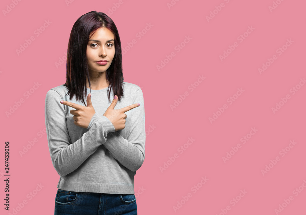 Young pretty woman confused and doubtful man, decide between two options, concept of indecision Young pretty woman confused and doubtful man, decide between two options, concept of indecision