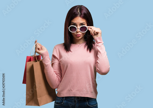 Young pretty woman cheerful and smiling, very excited carrying a shopping bags, ready to go shopping and look for new offers