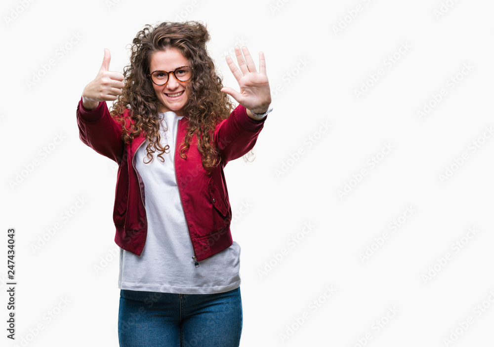 Beautiful brunette curly hair young girl wearing jacket and glasses over isolated background showing and pointing up with fingers number six while smiling confident and happy. Beautiful brunette curly hair young girl wearing jacket and glasses over isolated background showing and pointing up with fingers number six while smiling confident and happy.