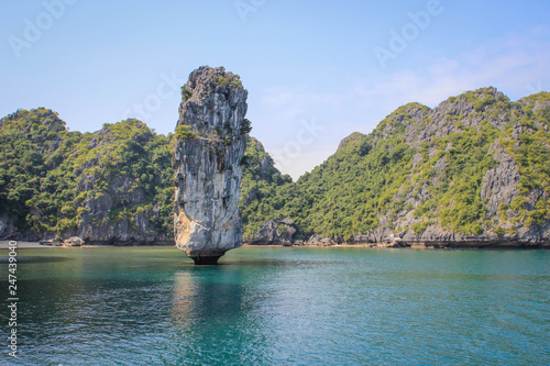 Stunning views of the quaint cliffs and the sea with turquoise water in the most famous place in Vietnam - Ha Long Bay.