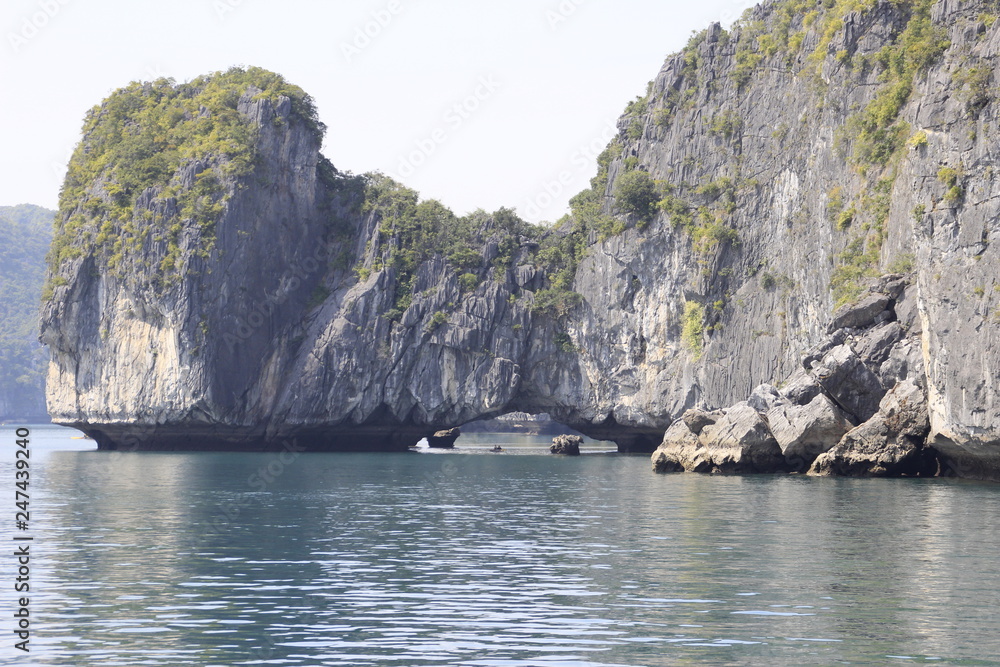 Stunning views of the quaint cliffs and the sea with turquoise water in the most famous place in Vietnam - Ha Long Bay. Stunning views of the quaint cliffs and the sea with turquoise water in the most famous place in Vietnam - Ha Long Bay.