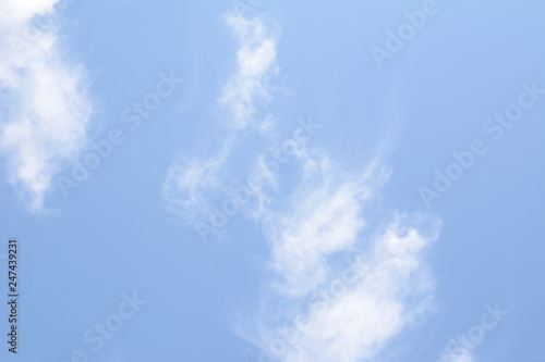 White feathery clouds on blue sky in summer