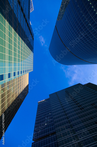 Moscow-City Mirrored skyscrapers business center. Over blue sky background.