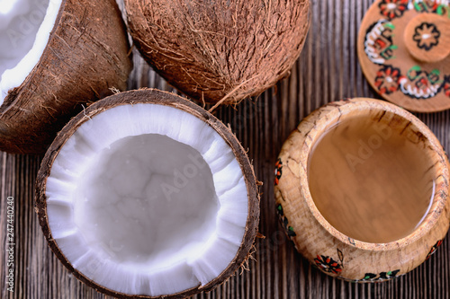 Juicy chopped coconut, coconut water in a wooden vessel and white coconut pulp are ready for use in cooking