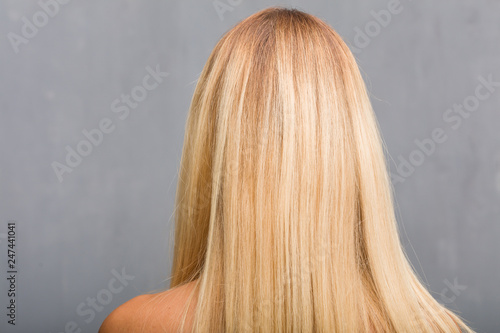 Face closeup, portrait of a natural young blonde woman showing back, posing and waiting, looking back