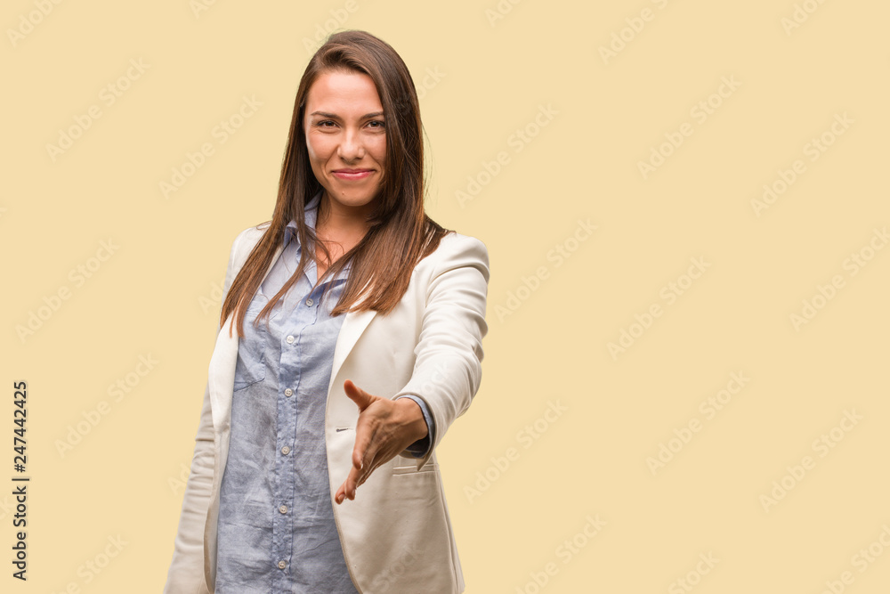 Caucasian business young woman reaching out to greet someone Caucasian business young woman reaching out to greet someone