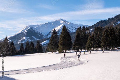 Some adults running cross-country skiing in snow-covered holdiday resort Hohentauern photo