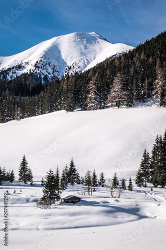 Snow covered frozen lake in holiday-resort Hohentauern on winter day