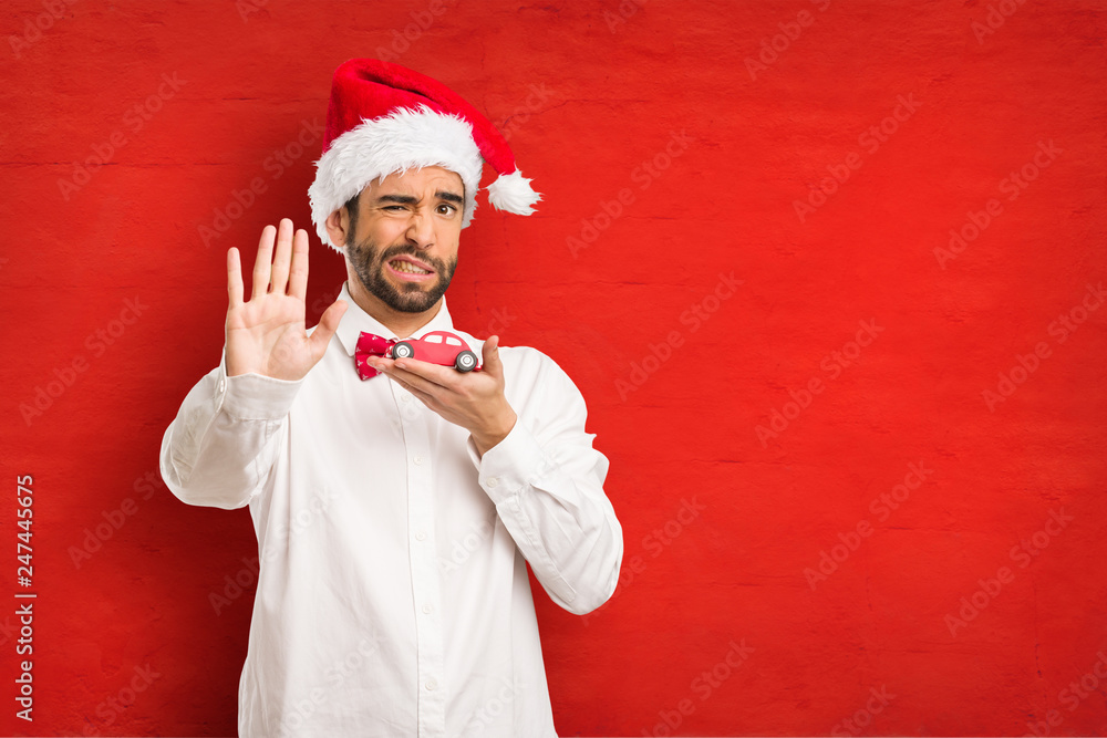 Young man wearing a santa claus hat on Christmas day Young man wearing a santa claus hat on Christmas day