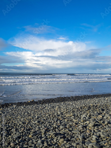 The waves roll in under a beautiful sky at Westward Ho! in North Devon , England