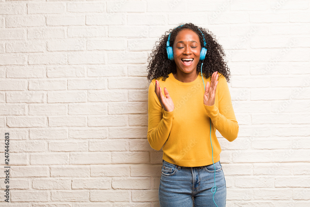 Young black woman laughing and having fun, being relaxed and cheerful, feels confident and successful Young black woman laughing and having fun, being relaxed and cheerful, feels confident and successful