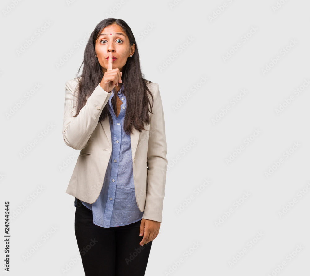 Young business indian woman keeping a secret or asking for silence, serious face, obedience concept Young business indian woman keeping a secret or asking for silence, serious face, obedience concept
