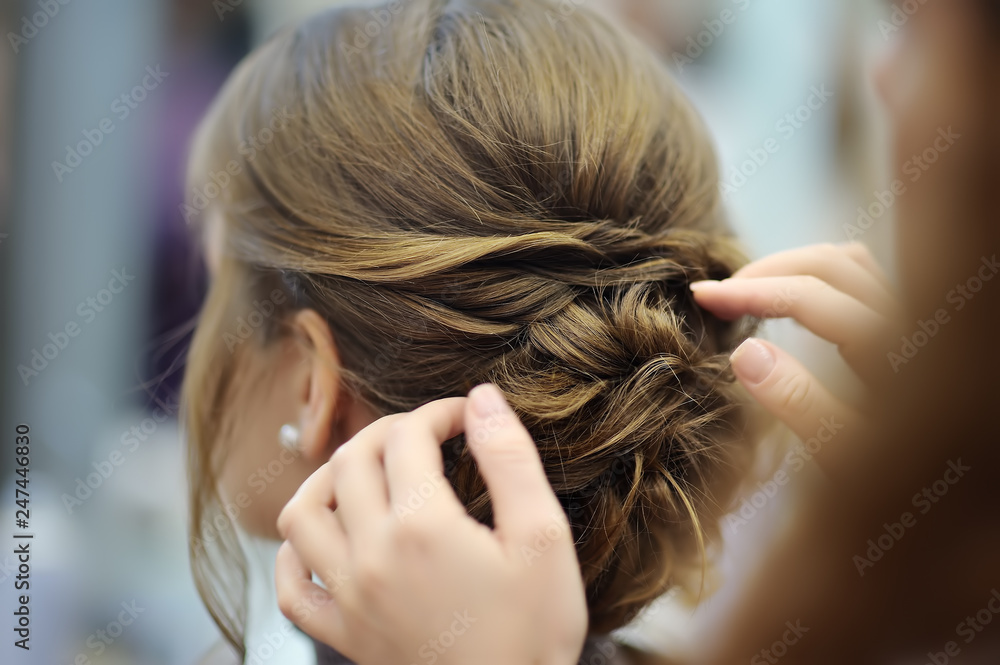 Fototapeta premium Young woman/bride getting her hair done before wedding or party