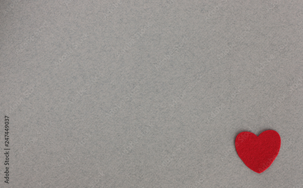 Obraz premium red felt hearts on grey background with place for inscription