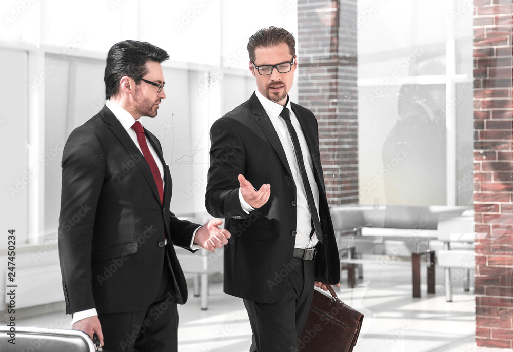 Two businessmen discussing business in office Two businessmen discussing business in office