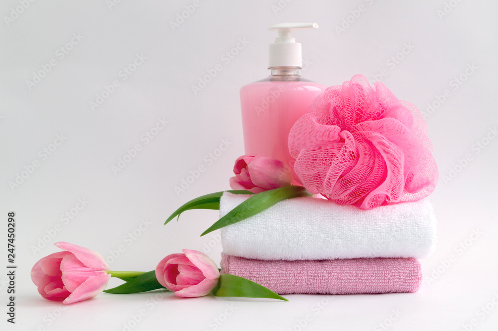 Liquid soap and two towels on a white background. Liquid soap and two towels on a white background.