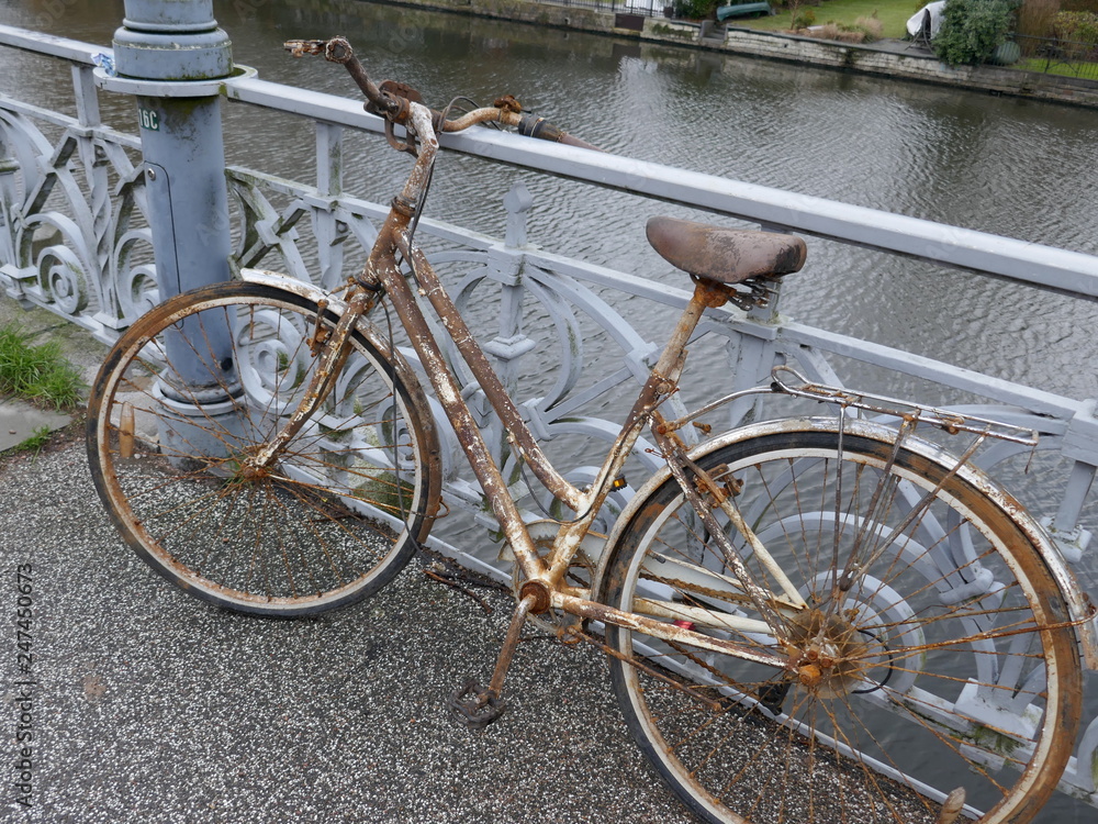 Old rusty lady's bicycle, parked at a bridge railing and then forgotten
Old rusty lady's bicycle, parked at a bridge railing and then forgotten