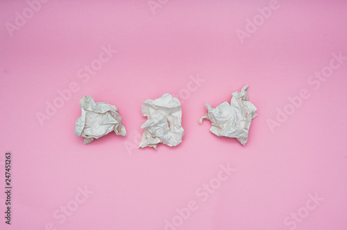 Lump crumpled paper on pink background. Eco friendly concept. Copy space. Flat lay.