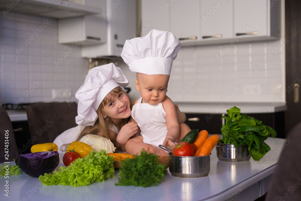 little girl and boy, white chef hat, vegetables little girl and boy, white chef hat, vegetables