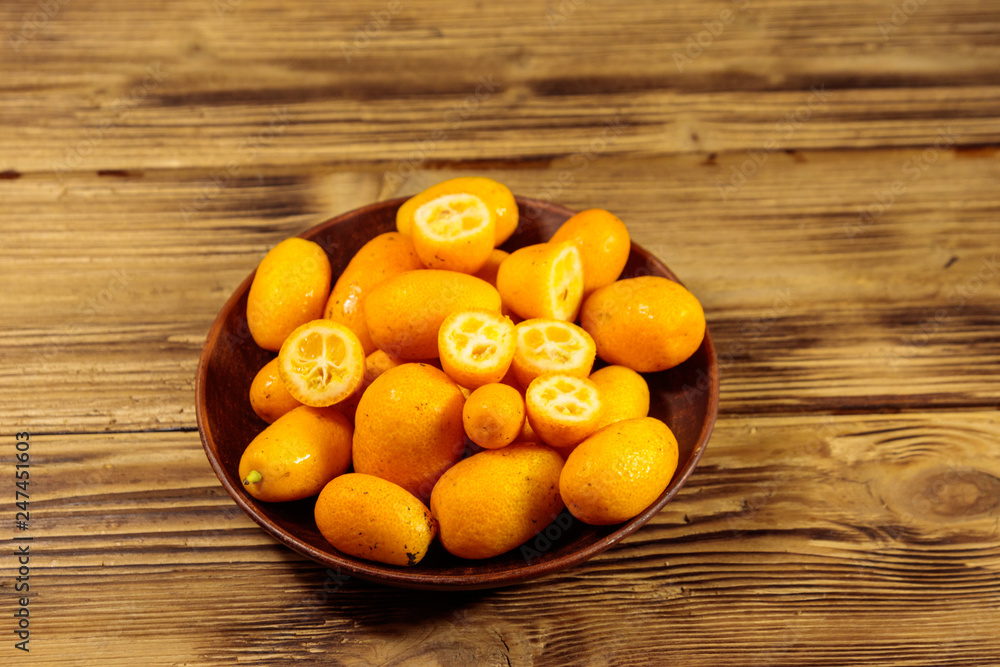 Fresh kumquat fruits on wooden table