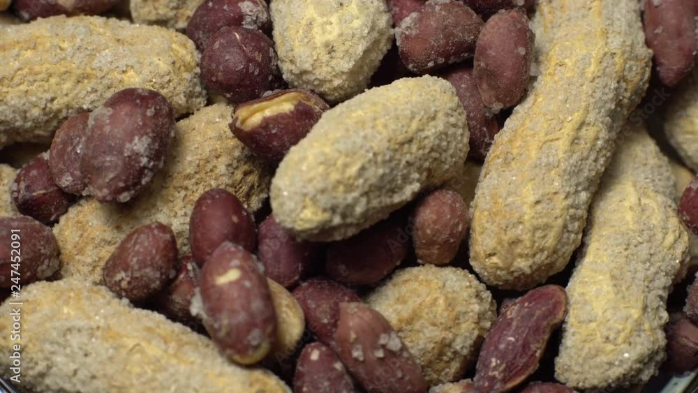 Peanuts. Mixed Peanuts in rotation. Snack closeup. Peanuts in a bowl. Selective focus. Studio shot. Healthy food concept. Peanuts. Mixed Peanuts in rotation. Snack closeup. Peanuts in a bowl. Selective focus. Studio shot. Healthy food concept.