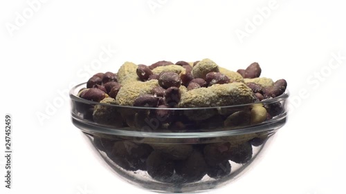 Peanuts. Mixed Peanuts in rotation. Snack closeup.   Peanuts in a bowl. Selective focus. Isolated on white. Studio shot. Healthy food concept.