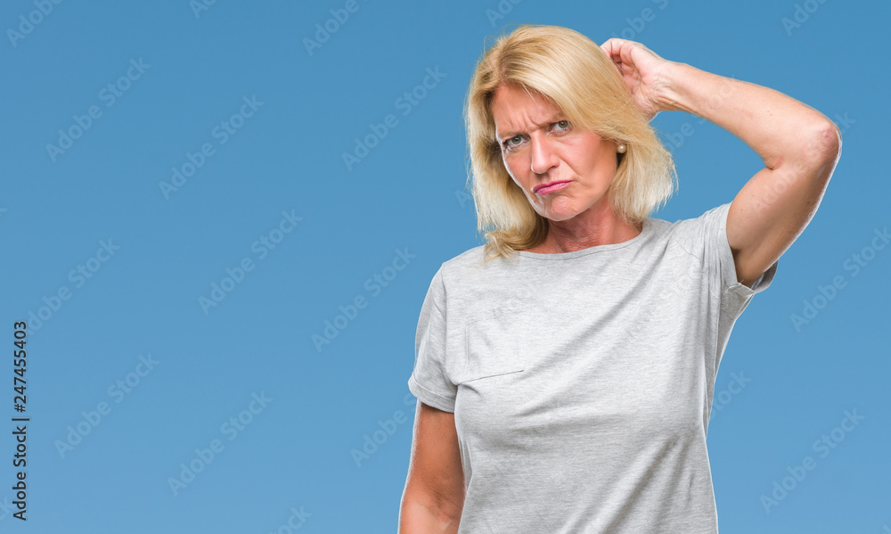 Middle age blonde woman over isolated background confuse and wonder about question. Uncertain with doubt, thinking with hand on head. Pensive concept. Middle age blonde woman over isolated background confuse and wonder about question. Uncertain with doubt, thinking with hand on head. Pensive concept.