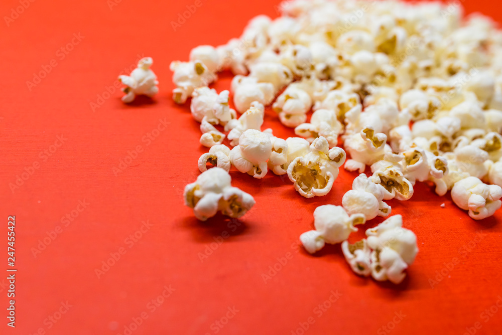 Tasty salted popcorn isolated on red background. Popcorn border isolated on red, clipping path included. Cinema, movies and entertainment concept. Tasty salted popcorn isolated on red background. Popcorn border isolated on red, clipping path included. Cinema, movies and entertainment concept.