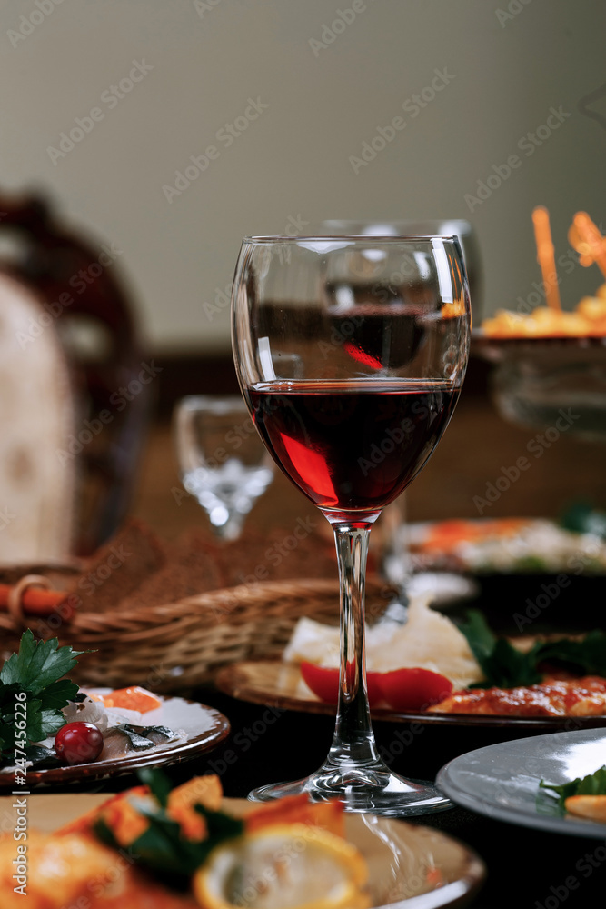 A glass of red wine on the table before dinner A glass of red wine on the table before dinner