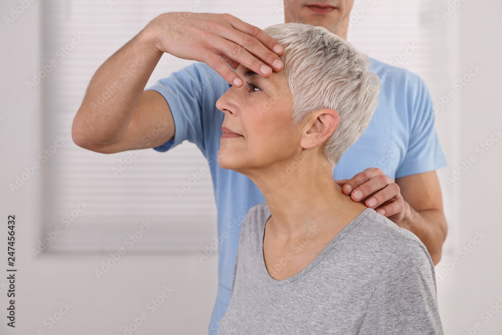 Fototapeta premium Mature Woman having chiropractic adjustment. Osteopathy, Physiotherapy, acupressure, holistic care