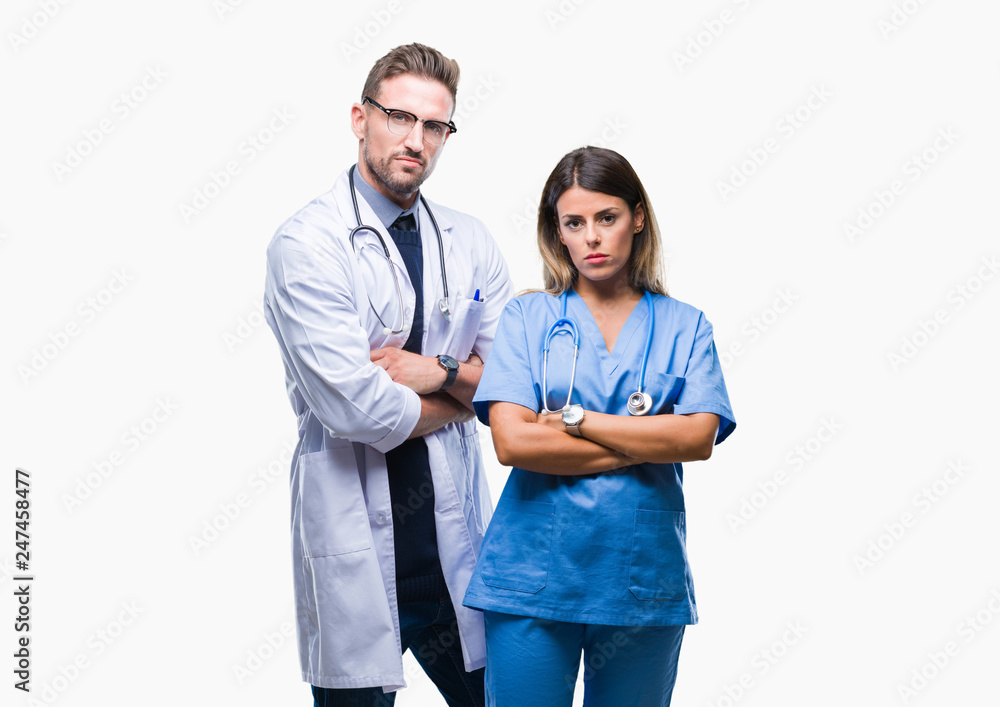Young couple of doctor and surgeon over isolated background skeptic and nervous, disapproving expression on face with crossed arms. Negative person. Young couple of doctor and surgeon over isolated background skeptic and nervous, disapproving expression on face with crossed arms. Negative person.