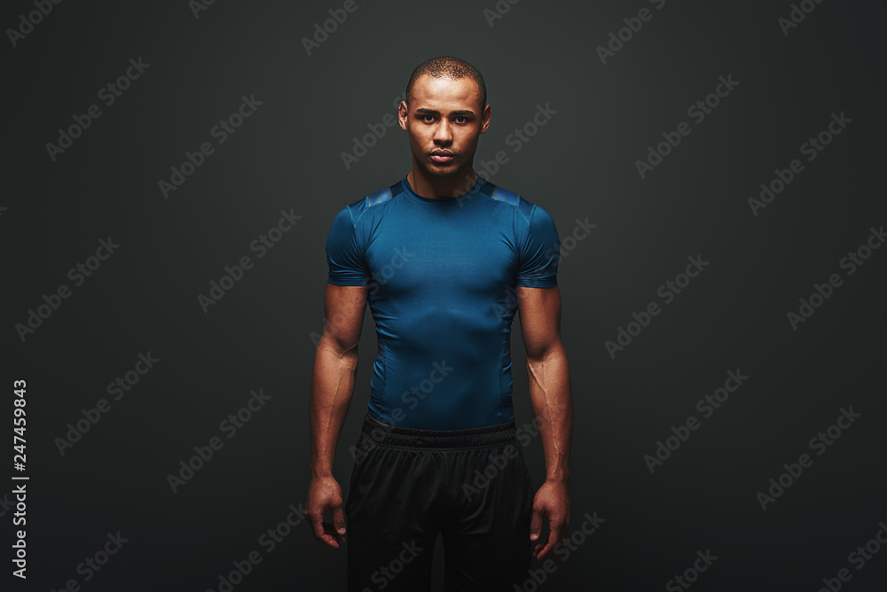 The only bad workout is the one that didn't happen. Handsome sportsman standing over dark background