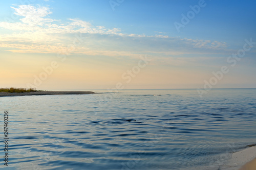 Stream in the sea strait at sunset background.