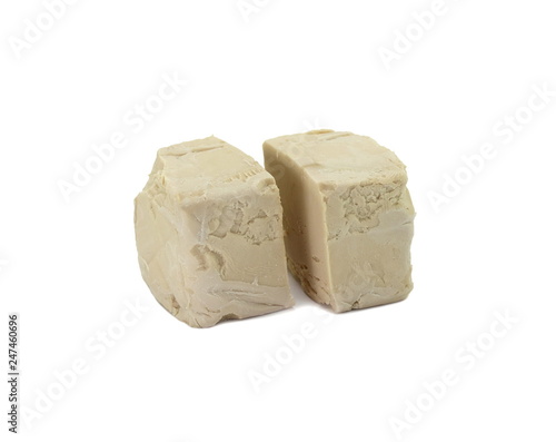 Baker's yeast isolated on white background. A block of compressed fresh yeast isolated.