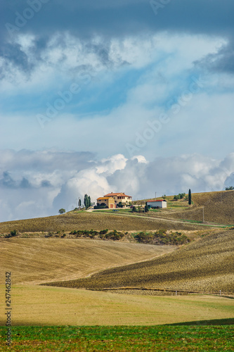 Villa in Italy, old farmhouse in the waves of tuscanian fields and hills © 31etc