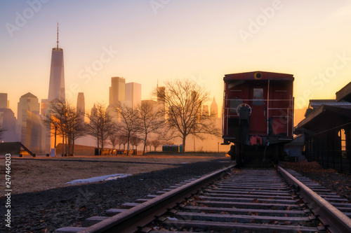 Golden sunrise over Liberty State Park, Featuring abandoned railroad tracks on the foreground and New York City skyline on the background. High dynamic range photography photo