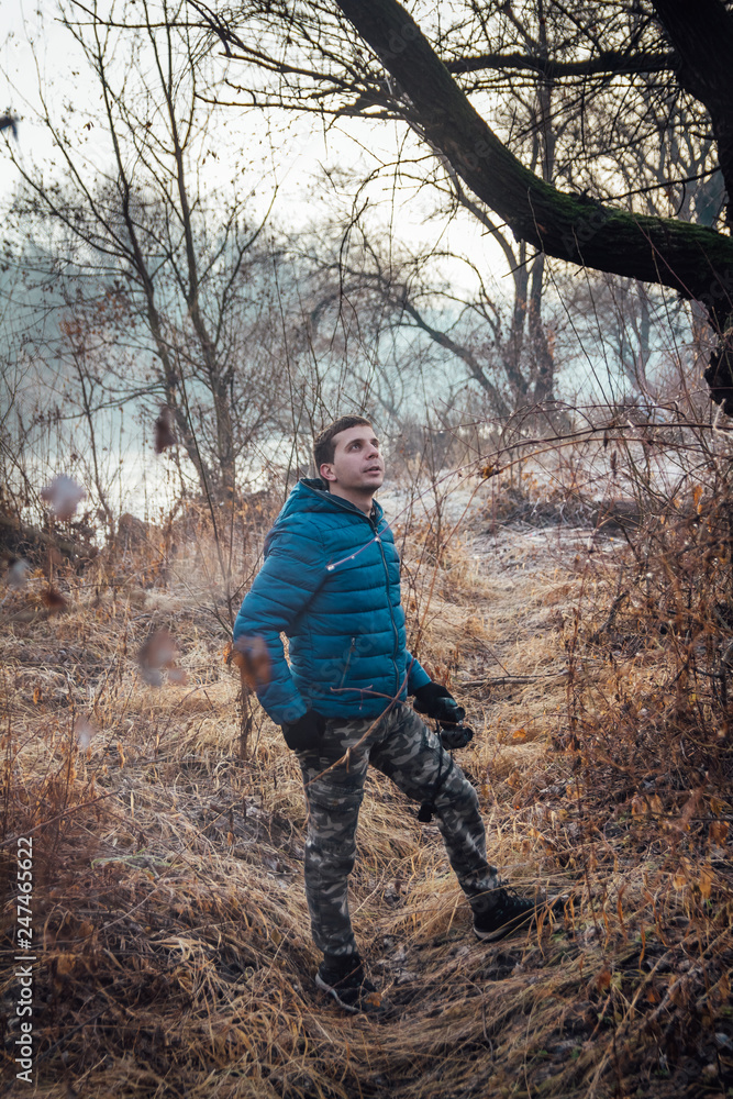 Young ornithologist hiking trough forest and watching birds Young ornithologist hiking trough forest and watching birds