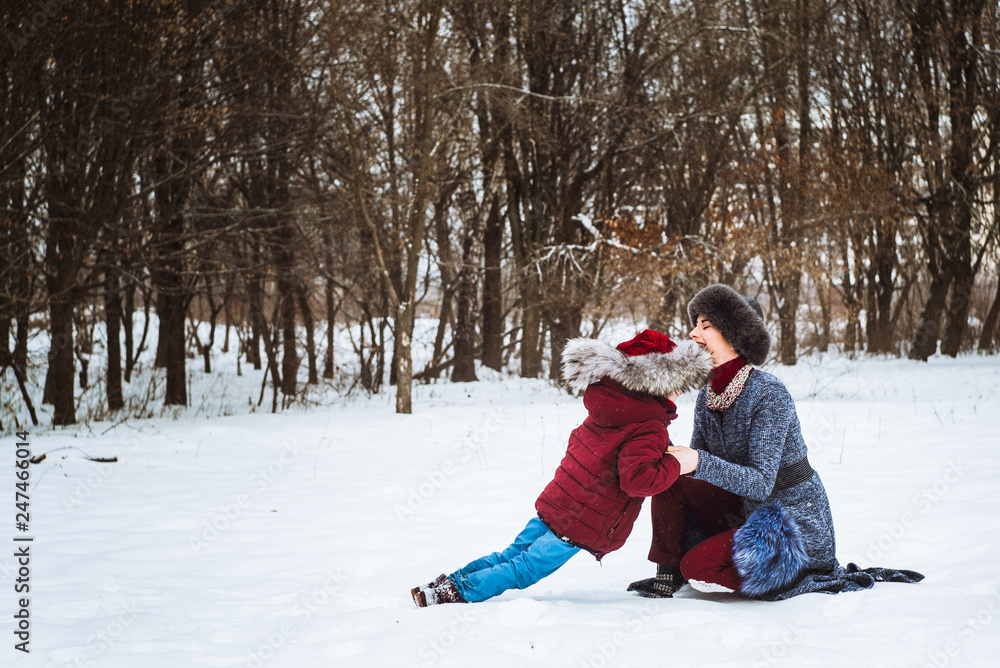 girl with mom playing in winter 2