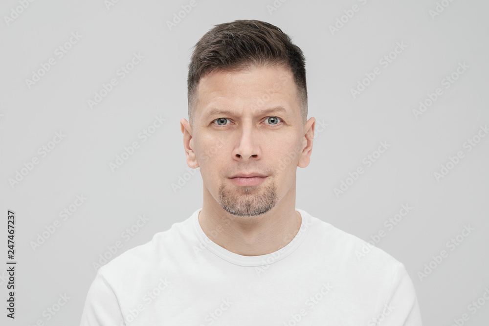 Futuristic handsome bearded brunet man 40s years in white clothes on a white background close-up. God, teacher and boss. Futuristic handsome bearded brunet man 40s years in white clothes on a white background close-up. God, teacher and boss.