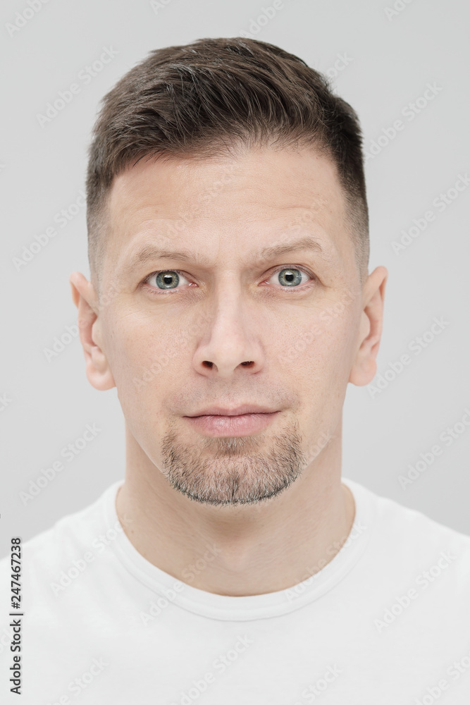 Futuristic handsome bearded brunet man 40s years in white clothes on a white background close-up. God, teacher and boss. Futuristic handsome bearded brunet man 40s years in white clothes on a white background close-up. God, teacher and boss.