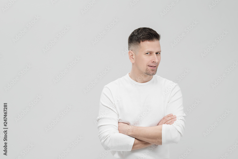 Futuristic handsome bearded brunet man 40s years in white clothes on a white background with folded arms, portrait. God, teacher and boss. Futuristic handsome bearded brunet man 40s years in white clothes on a white background with folded arms, portrait. God, teacher and boss.